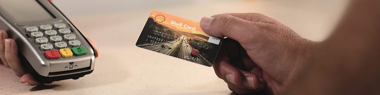 hands holding euroshell card DK