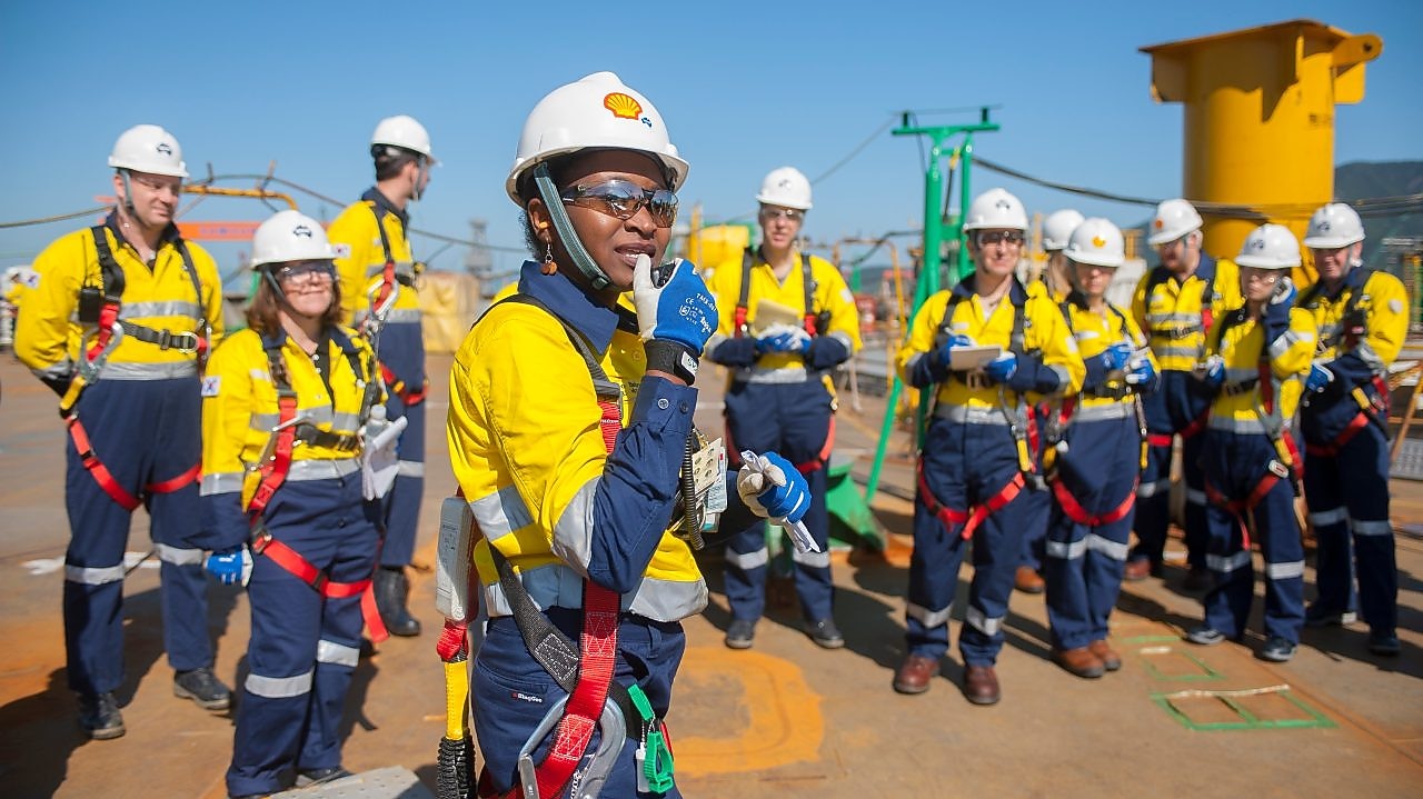 A female Shell engineer leading her team at an operational site.