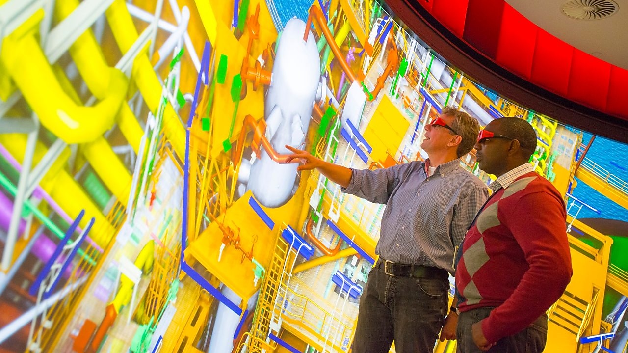 Two Shell employees with 3D glasses looking at an interactive map